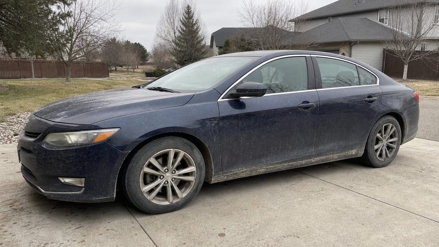 Sedan before detailing — dull paint, grime on the panels.